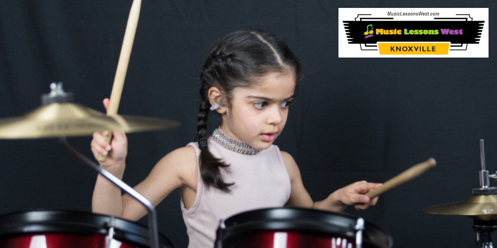 Featured image for "Drum Lessons Nashville TN" page on MusicLessonsNashville.com depicting young girl approximately 5 years old playing drum set.